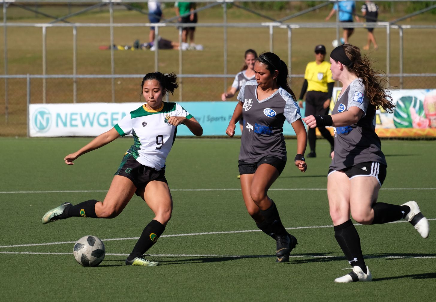 UOG's Ariya Cruz, No. 9, moves the ball upfield against two opponents. Cruz scored two of UOG's six goals in the March 10 match.