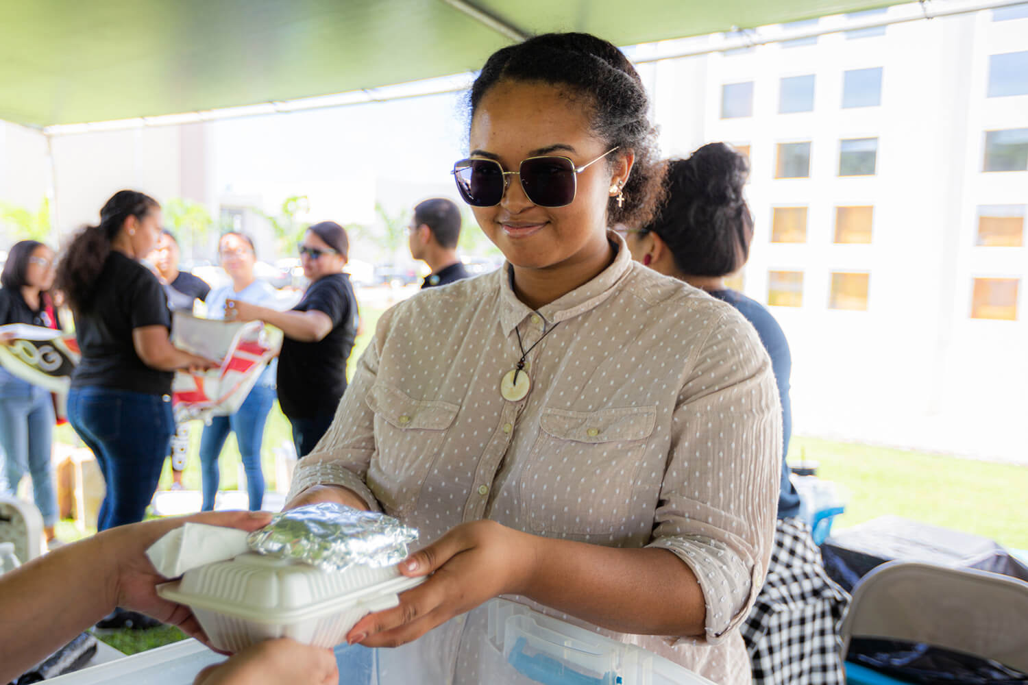 C’Lita Taitanohands out food during the community service project of the UOG CLASS on Nov. 22.