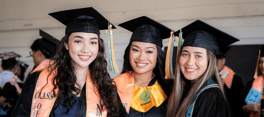 Photo of three female Triton students during commencement