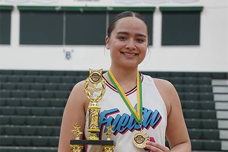 Mia San Nicolas poses with trophy and medal