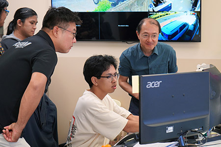 A UOG computer science student installs a program he developed at a local car rental agency. 