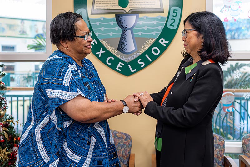 photo of two women shaking hands