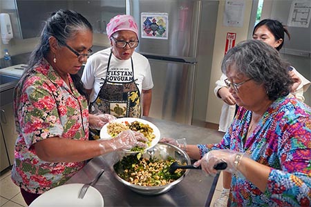 Workshop participants prepare tofu kelaguen at a healthy cooking class offered by UOG Extension.