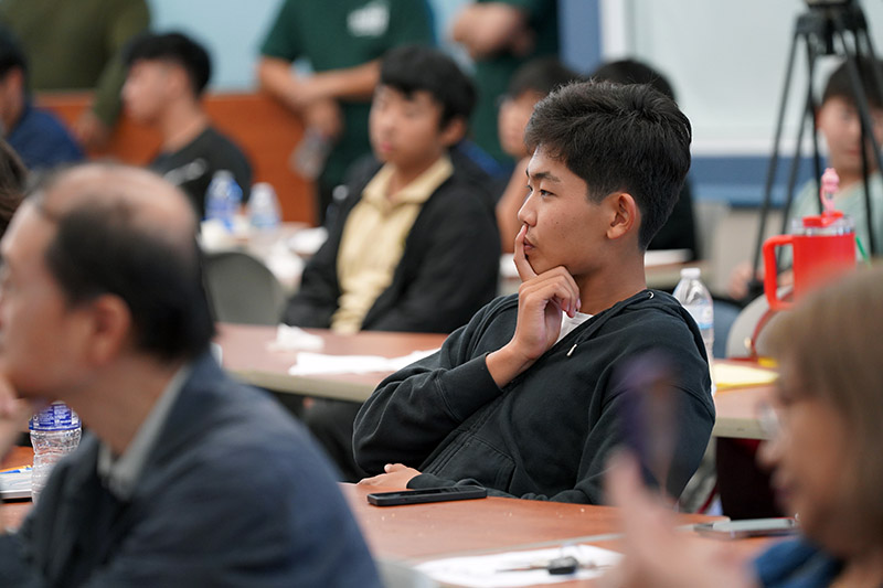 A boy thinking during a lecture