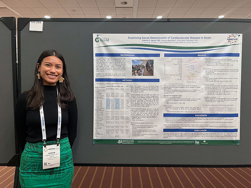 Woman standing by a research poster