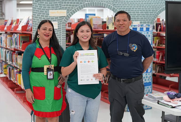 School counselor and J.Q. San Miguel Principal pose for photo with UOG extension associate with SNAP-Ed program.