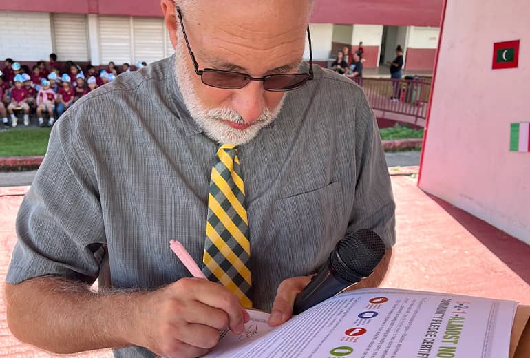 H.B. Price Elementary school principal signs 5-2-1 Almost None pledge outdoors