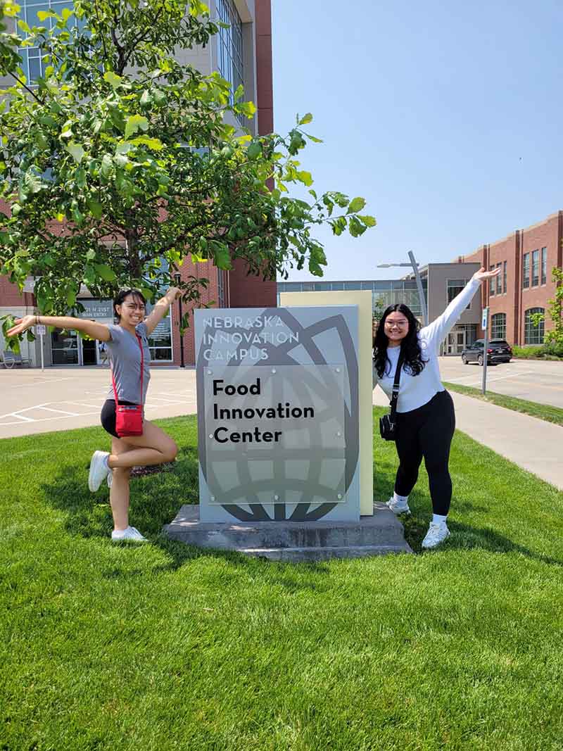 Photo of two students by a Food Innovation Center sign at University of Nebraska-Lincoln