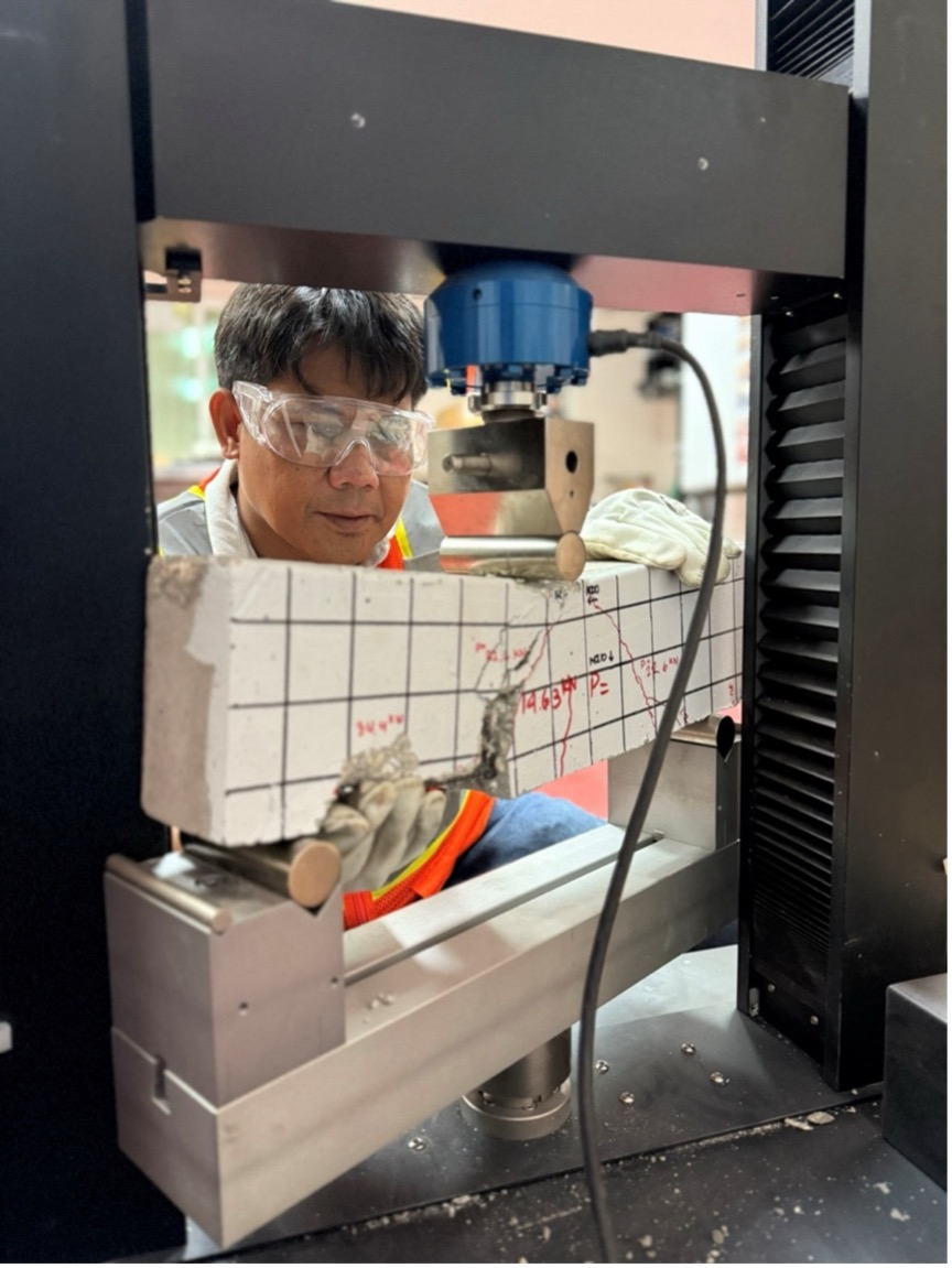 Dr. Ernesto J. Guades conducts a test on a concrete beam