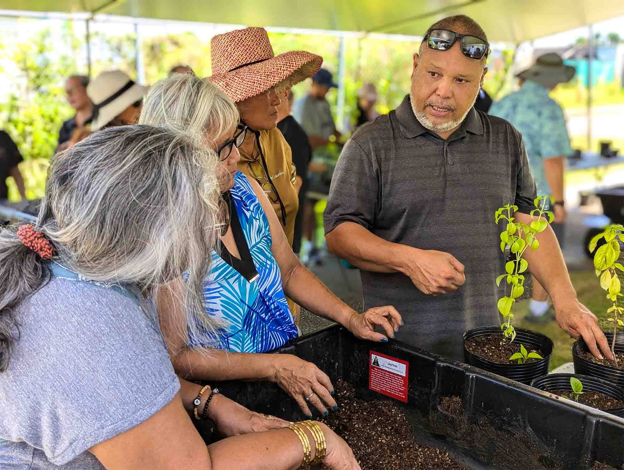 Mark Acosta, an extension agent of sustainable agriculture with University of Guam Cooperative Extension & Outreach, gives residents some tips on growing plants in containers during a workshop last July. Starting May 27, UOG Extension will hold a first-time Garden-to-Table Workshop, focusing on how to grow productive, low-maintenance food plants in a residential setting and how to cook with them.