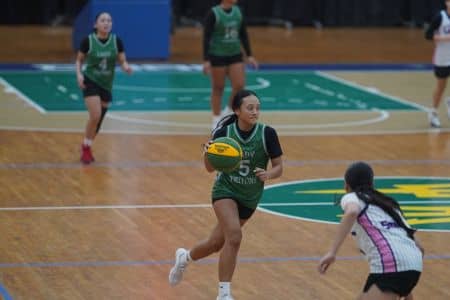 Lady Tritons playing basketball against stingray grays