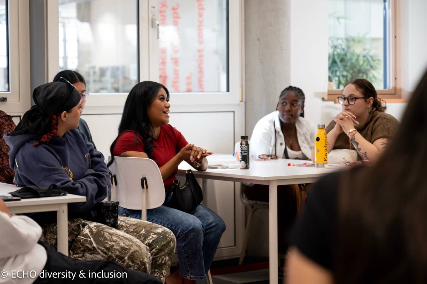 Tyra Delos Reyes, center, participates in a class discussion.
