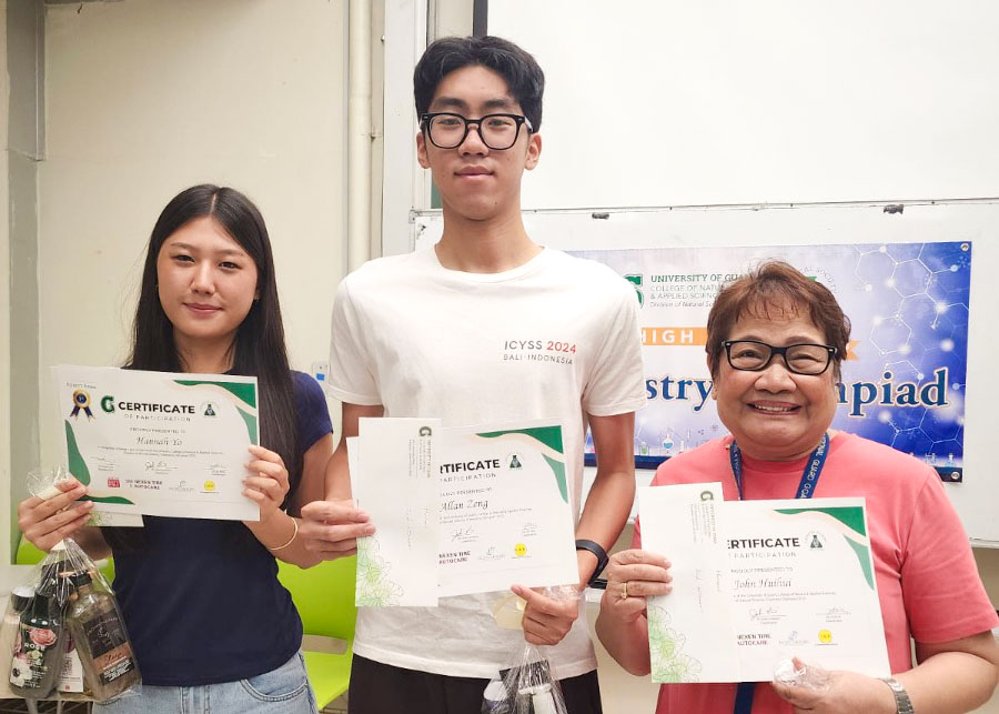 Honors Category exam winners of the 2025 UOG High School Chemistry Olympiad. (From left: Hannah Yo (1st place – Harvest Christian Academy), Allan Zeng (2nd place – Saint John’s School), and Mrs. Evangeline Mangune standing in for John Huihui (3rd place – Father Duenas Memorial School). Photo of 3 winners holding certificates