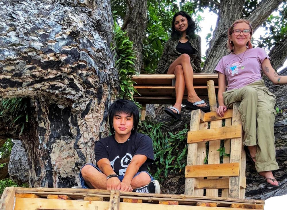 From concept to construction, this student-led project brought together artists from across class levels and majors. In this photo: Maria Sol Marques (right), Kai Chaco (left), are joined by a friend to showcase the art installation.
