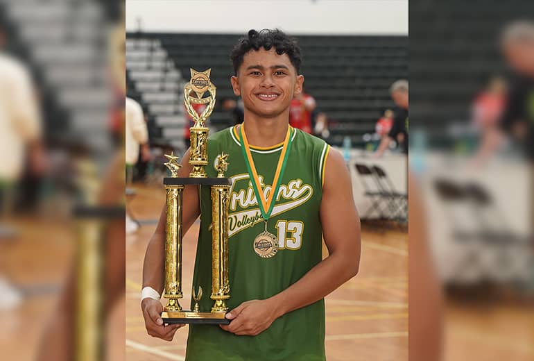 UOG Triton Men's Volleyball Team MVP poses for a photo holding trophy