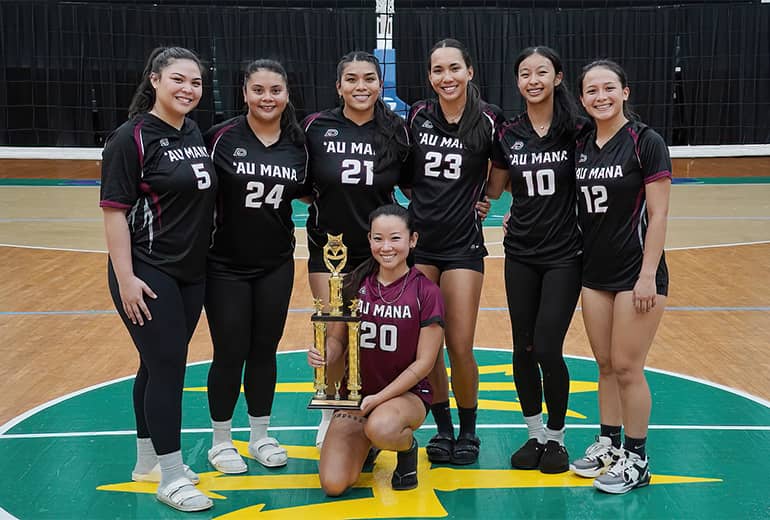 Au Mana volleyball team poses for a group photo with trophy