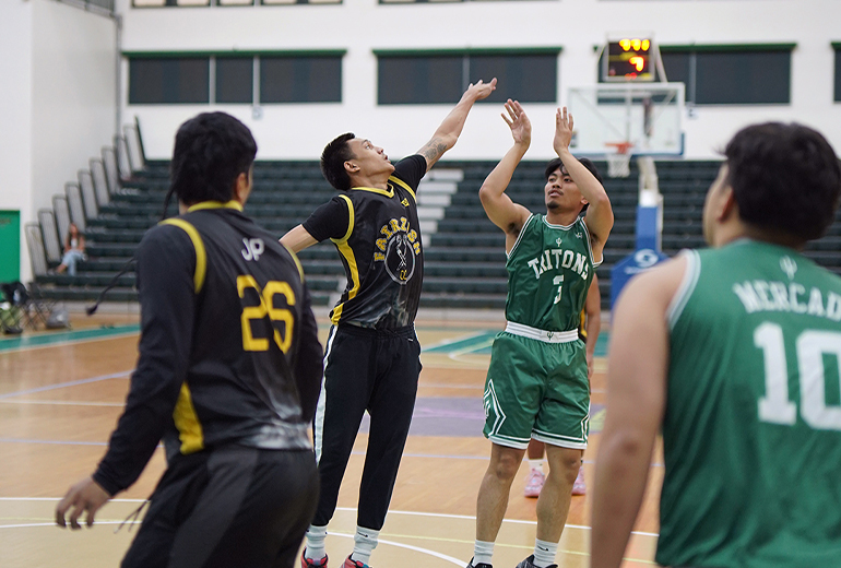 Player in black jersey attempts to black Triton player in green jersey’s shot