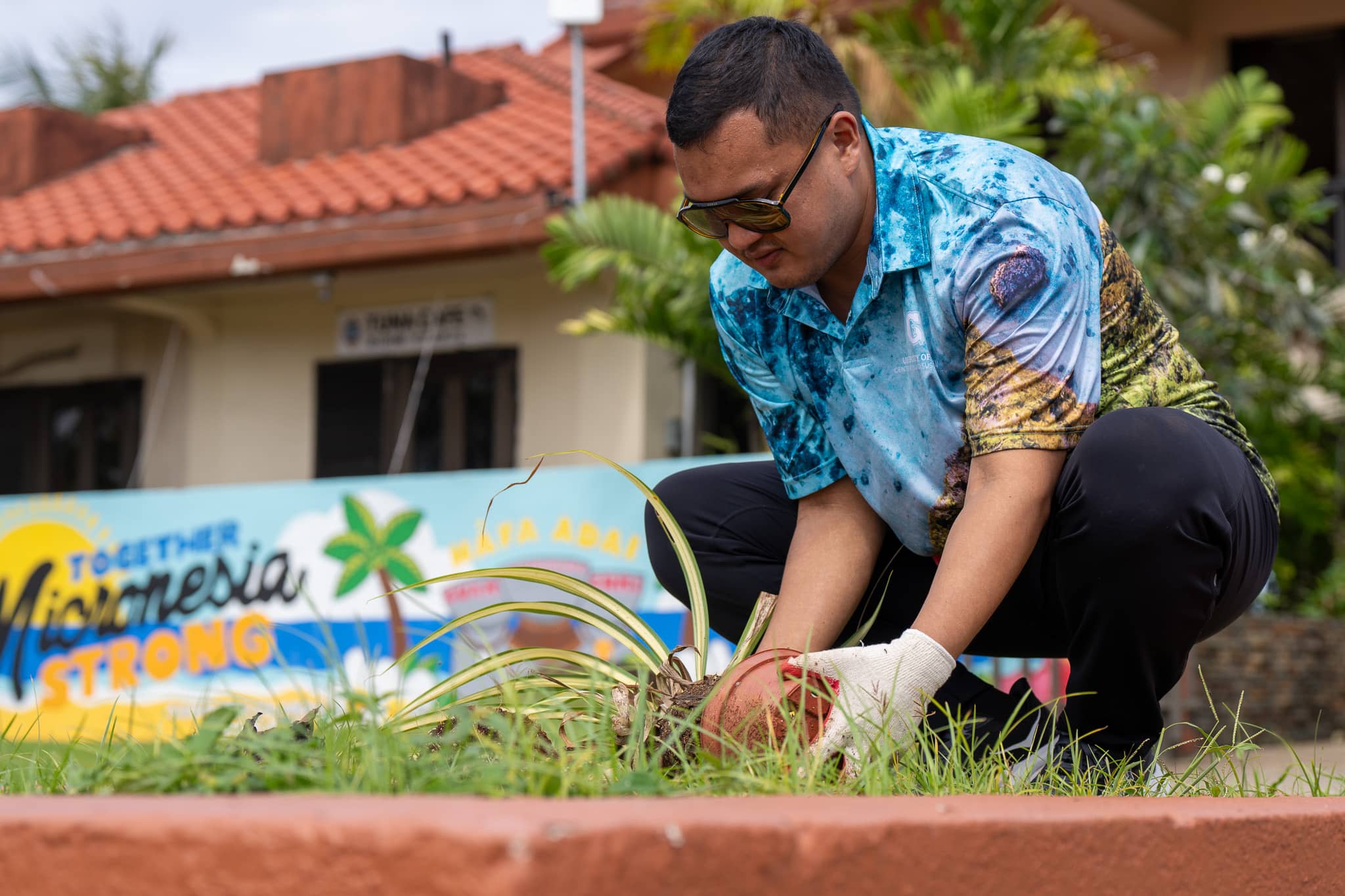 Volunteer planting a fruit tree at CHamoru Village