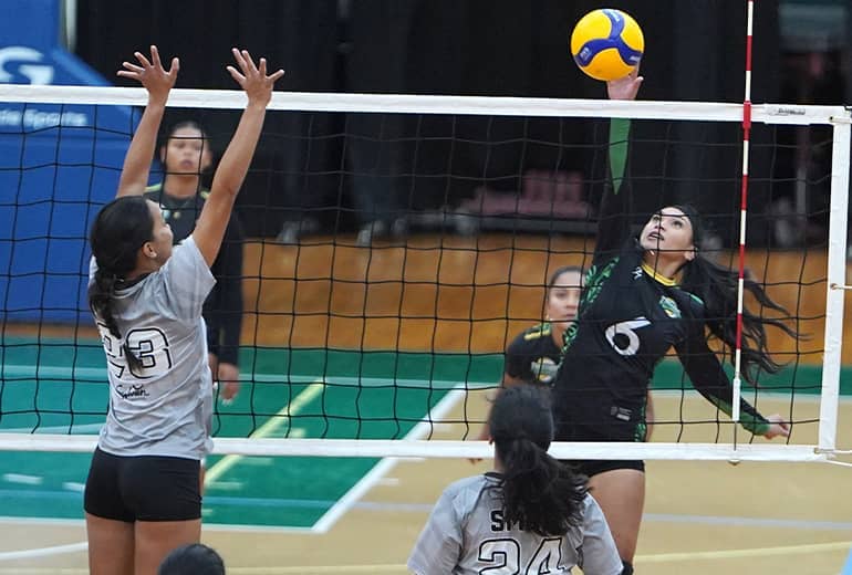 Lady triton spikes ball - action shot