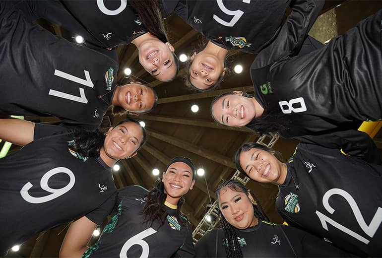 upward angle of lady tritons huddled for a photo