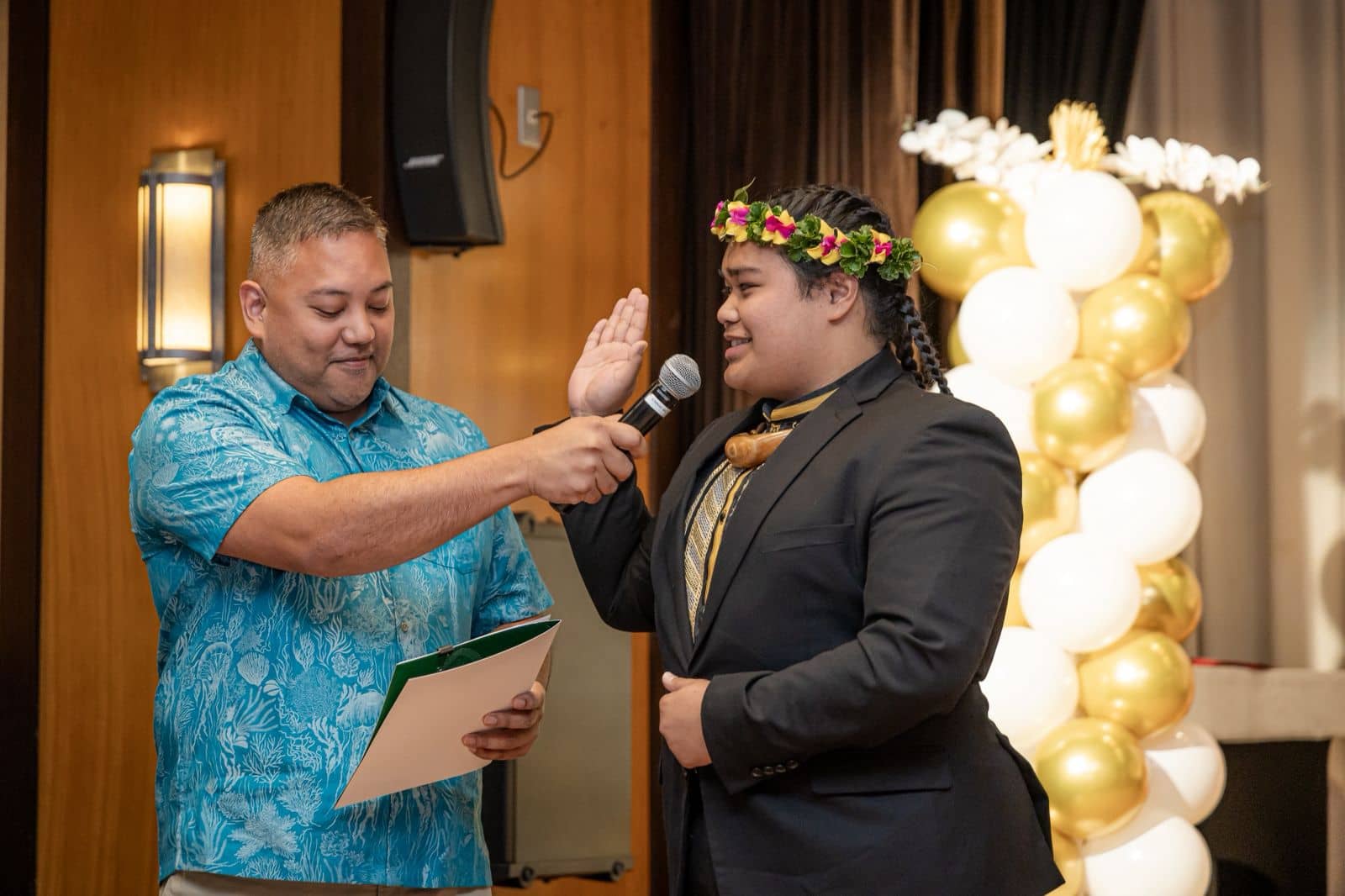 Devin Calvo Santos (right), takes the oath of office as Student Regent with University of Guam Board of Regents Chairperson Agapito “Pete” Diaz (left) presiding during the SGA inauguration ceremony