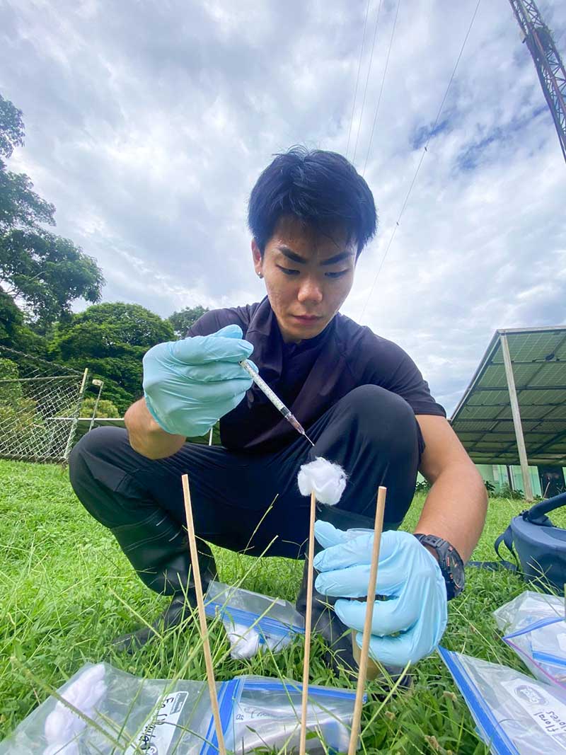 UOG biology major William Minami conducts a science experiement outside in Costa Rica during his semester-long study-abroad experience through the NextGen COMPASS Program at UOG. A student holding a syringe and conducting a science experiment outdoors