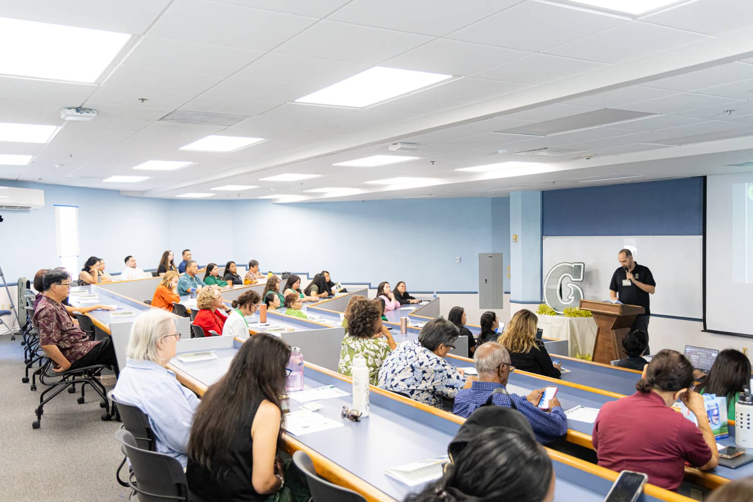 Attendees listen in on a presentation by Dr. Carlos Madrid, Director of the Richard F. Taitano Micronesian Area Research Center at the University of Guam, during the Inaugural Research Forum held on August 9, 2024 on the Mangilao campus.