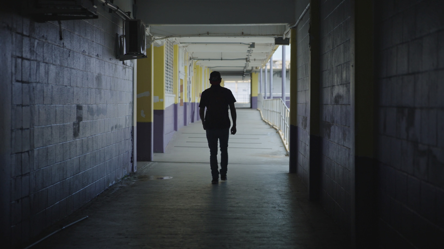 Man walking up a school hallway